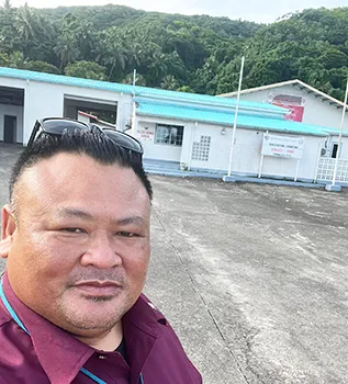 Faipule Luaitaua Gene Pan in front of the Fagaitua East Substation