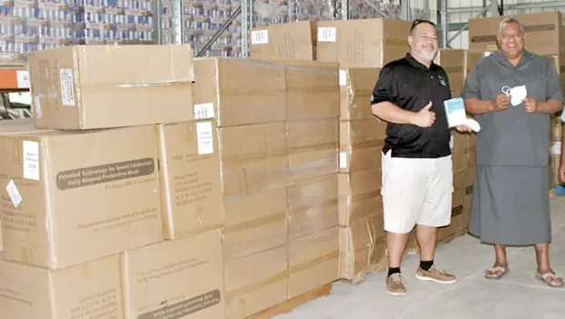 Gov. Lemanu Peleti Palepoi Sialega Mauga with Ziggy Vollrath and cartons of PPE