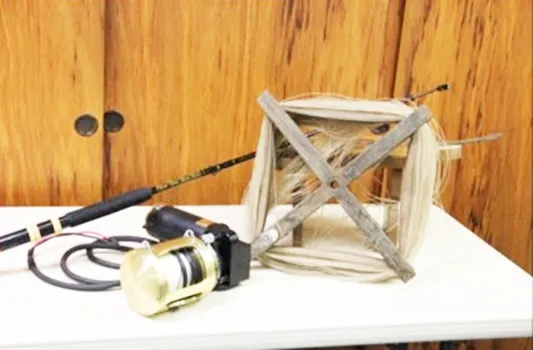 hand cranked reel beside an electric reel