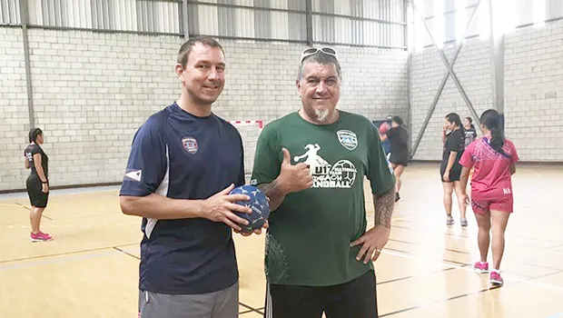 American Samoa Handball Association (ASHA) president and head coach Carl Floor Sr., and ASBA coach Michael Marsik with American Samoa’s U20 Women’s Handball Team practicing in the background
