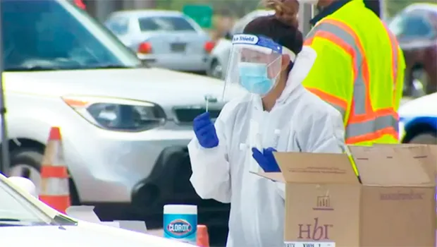 Surge testing site on Oahu where medical personnel are beside a car