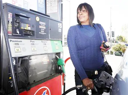 woman pumping gasoline into her car