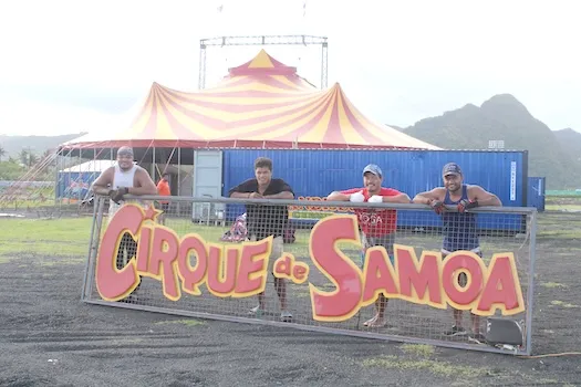 Employees of The Magic Circus of Samoa posing with their sign