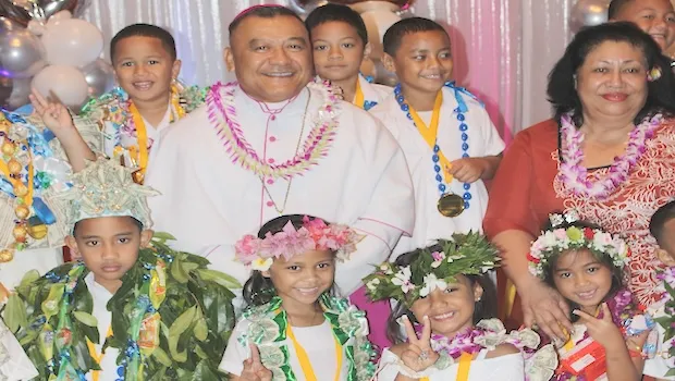 Bishop Kolio Tunamuvao Etuale poses with some of the K5 graduates of Fatuoaiga Montessori School 