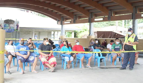 Inter-island wharf with people waiting for cargo under new system