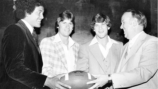(from left) Jack Thompson of Washington State, Chuck Fusina of Penn Satate and Rich Leach of Michigan pose with USC coach John Robinson 