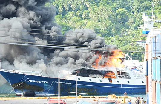 Fishing vessel Jeanette on fire at the dock in Pago Pago harbor