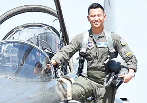 2nd LT Hanyoun Ao Jeong stepping into the cockpit of a jet airplane