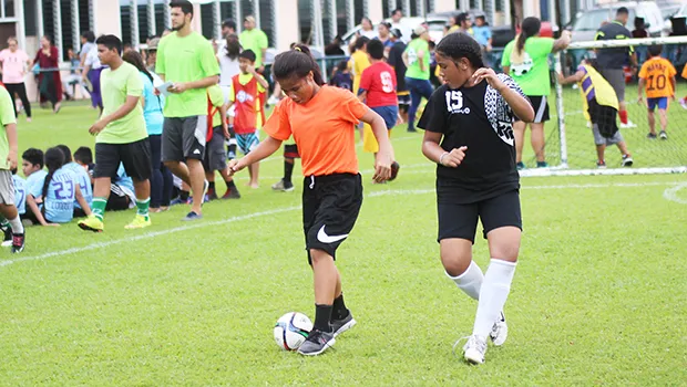 A Black Roses’ player dribbles against a Tafuna Jets’ opponen