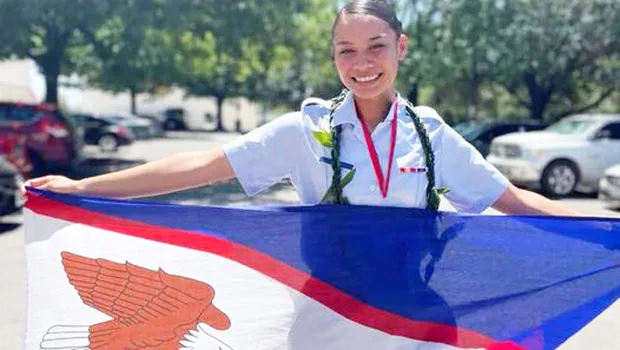 Joanya Tafua holding the American Samoa flag