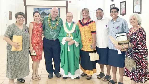 Karl Prendergast (third left) and Bishop Peter Brown (4th left) and other Holy Family parishioners 