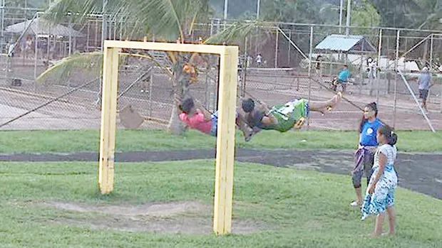Children swinging on playground equipment at Lions Park