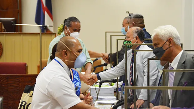 Dr. Akapusi Ledua shakes hands with Rep. Larry Sanitoa