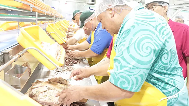 Gov. Lemanu P. S. Mauga and staff on the fish cleaning line at StarKist Samoa