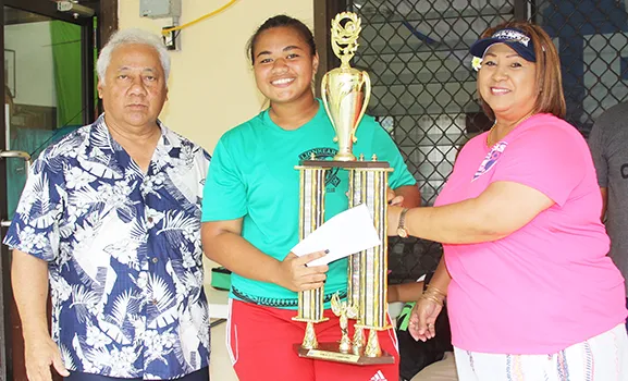 Pisita Lui of Lion Heart’s Girls 13-15 team receives the championship trophy