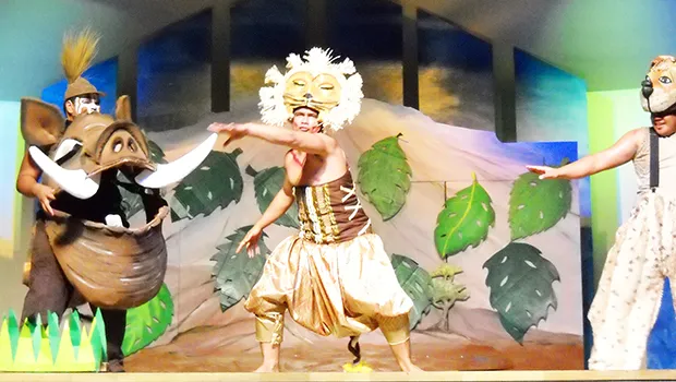 Ace Fuimaono and other actors in scene from Lion King