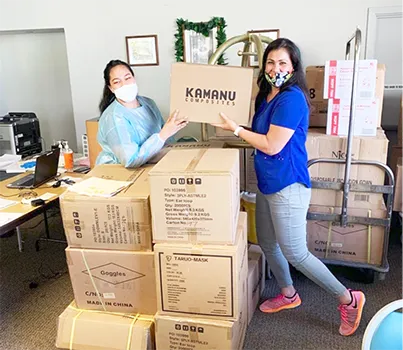 Two women receiving donated items in boxes
