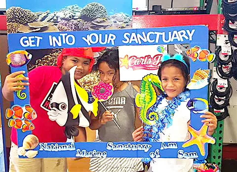 Three of the more than 300 kids and adults who took the virtual reality diving tour this past Saturday