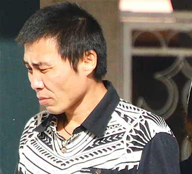 Tao Liu departing the court house after sentencing.  [photo: AF]