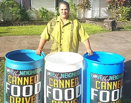 Tapumanaia Galu Satele Jr. with collection bins 