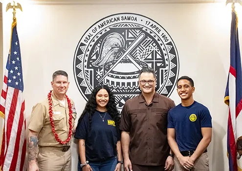 U. S. Navy Commander Robert L. Moran (left) and Lt. Gov Talauega E. V Ale with two young American Samoans 