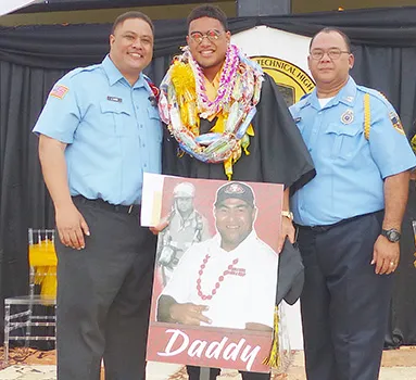 Malachi with portrait of his father and two firefighters
