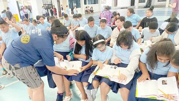 Manumalo Academy 3rd graders look through their new dictionaries