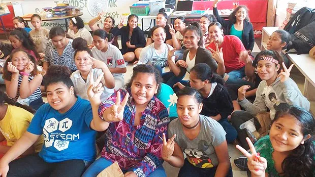 Some Level 7-8 students of Matafao Elementary School smile and wave to the camera