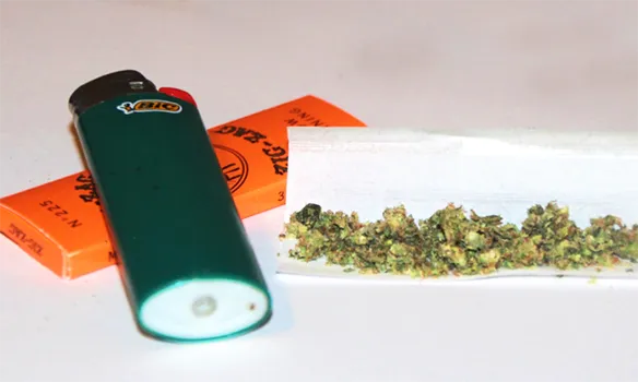 Marijuana buds, rolling papers and lighter
