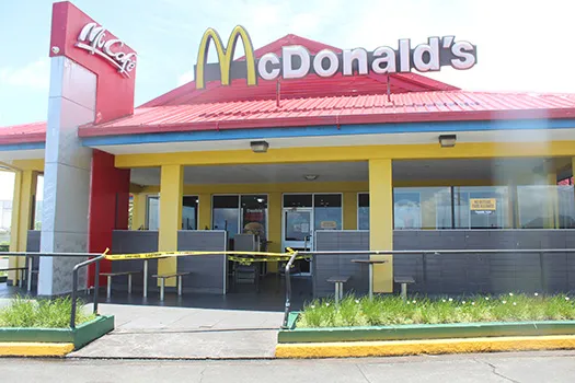 McDonald's with yellow tape around front door.