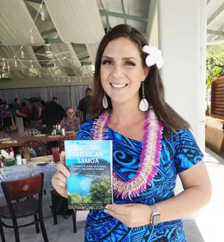 Melinda Laura Clayville holding the guidebook 