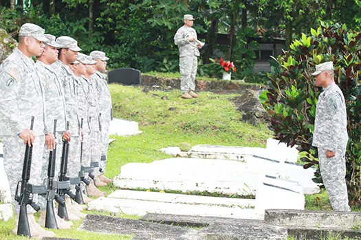 soldiers saluting graves on Memorial Day in American Samoa