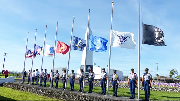 U.S.and American Samoa flags along with flags of the services at half staff