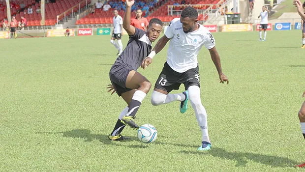 Milo Tiatia (left) of American Samoa battles for possession