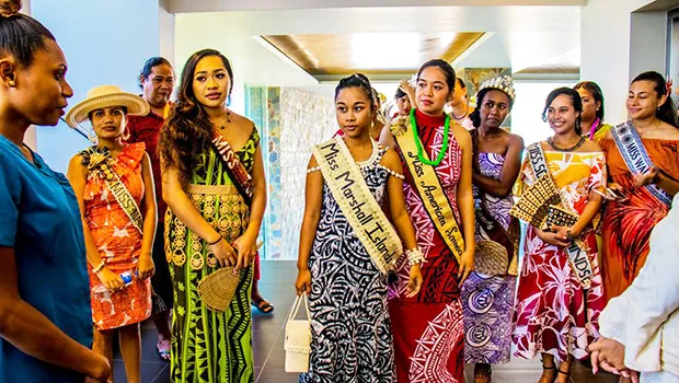 Miss American Samoa Epifania Petelo is center in red with many of the other contestants.