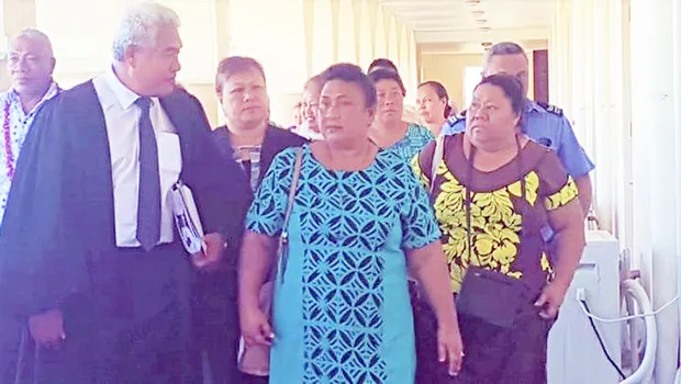 Leutogi Te'o (C) and Luse Tauvale (R) talking to their lawyer