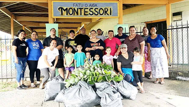Faculty and parents of Fatuoaiga Montessori School pose for a photo after an hour of picking up trash