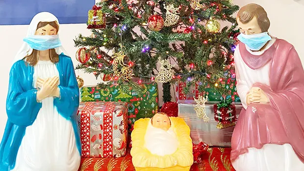 Nativity Scene in front of a Christmas Tree