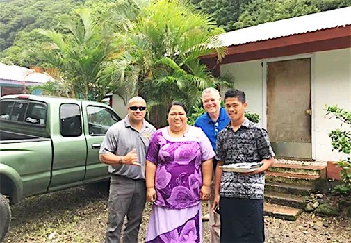Mrs. Asoiva Togafau (center), with John and Ricky Leulu (far right)