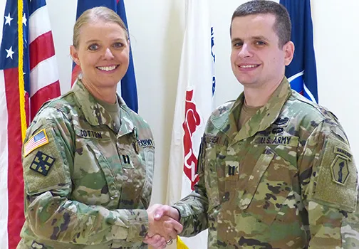 Cpt. Carneen Cotton (left) shaking hands with Capt. Timothy Shea