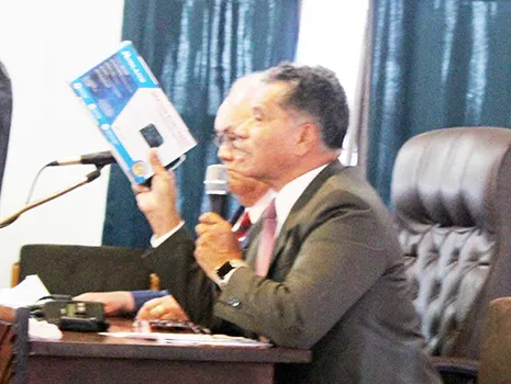  Samana Semo Ve’ave’a holds up for visual display the NOAA weather radio,