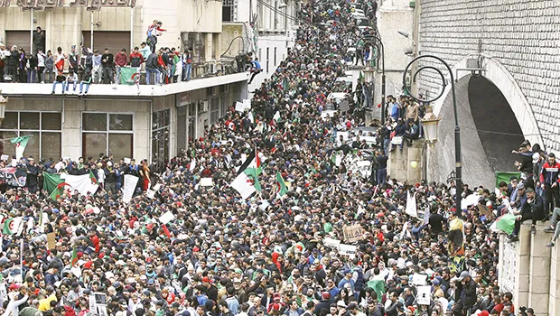 people gather for a demonstration in Algiers to protest President Abdelaziz Bouteflika's hold on power.