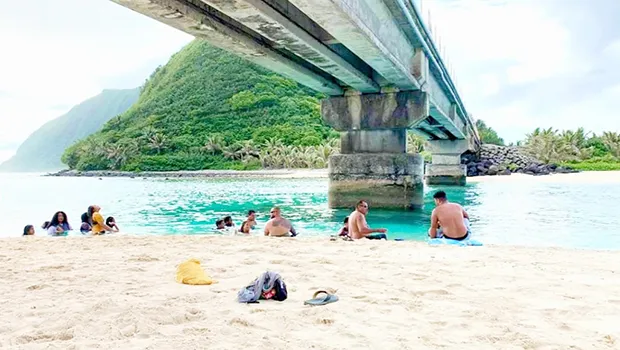 People swimming and relaxing under the Asaga Bridge