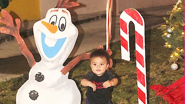 Child laughing as he sees the cartoon character Olaf 