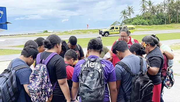 Olosega Elementary students bow their heads in prayer