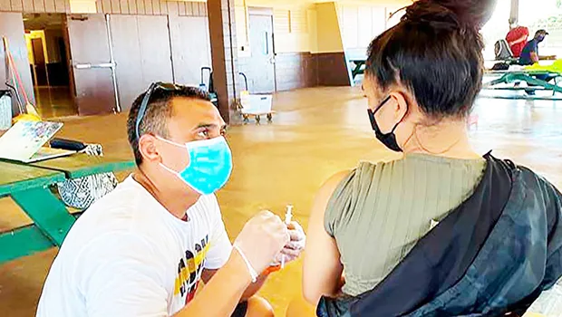Dr. Kapono Chong-Hanssen administers COVID-19 vaccines