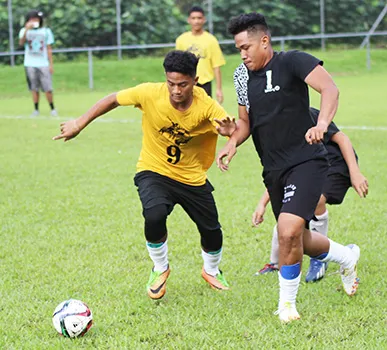 A Pago Youth player (left) and Tafuna Jets opponent 
