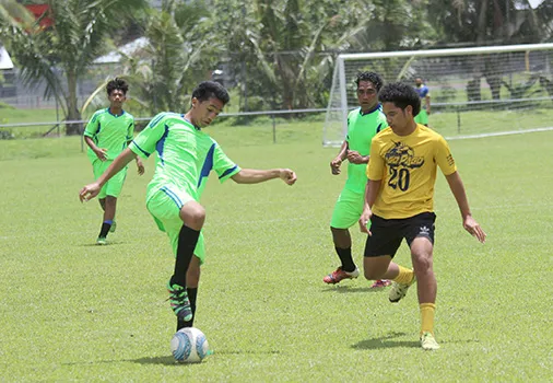 A Taputimu Youth player tries to control the ball 