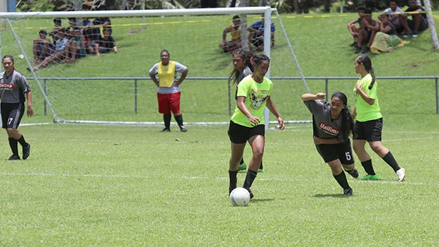 A Pago Youth player controls the ball against a Taputimu defender