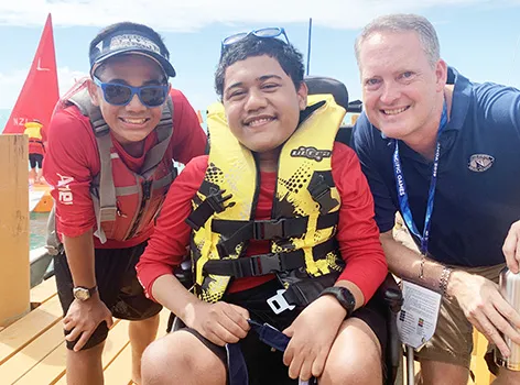 Alofaeleuma Faualo (center) with his crew 11-year old Laser Sailor Carneal Lili’o Satele and Tony Greubel, Charge de Affaires for the US Embassy